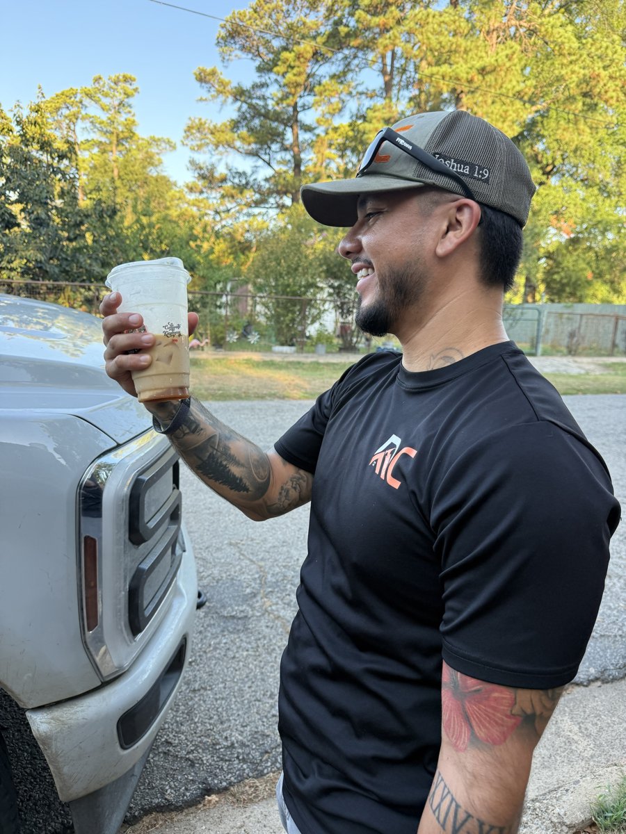 Christopher outside his truck with a drink